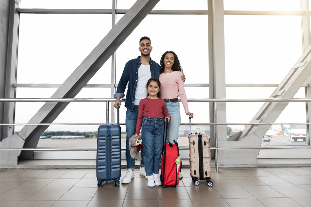 Portrait,Of,Happy,Arab,Family,With,Daughter,Standing,With,Suitcases A family visits a top country offering citizenship by investment