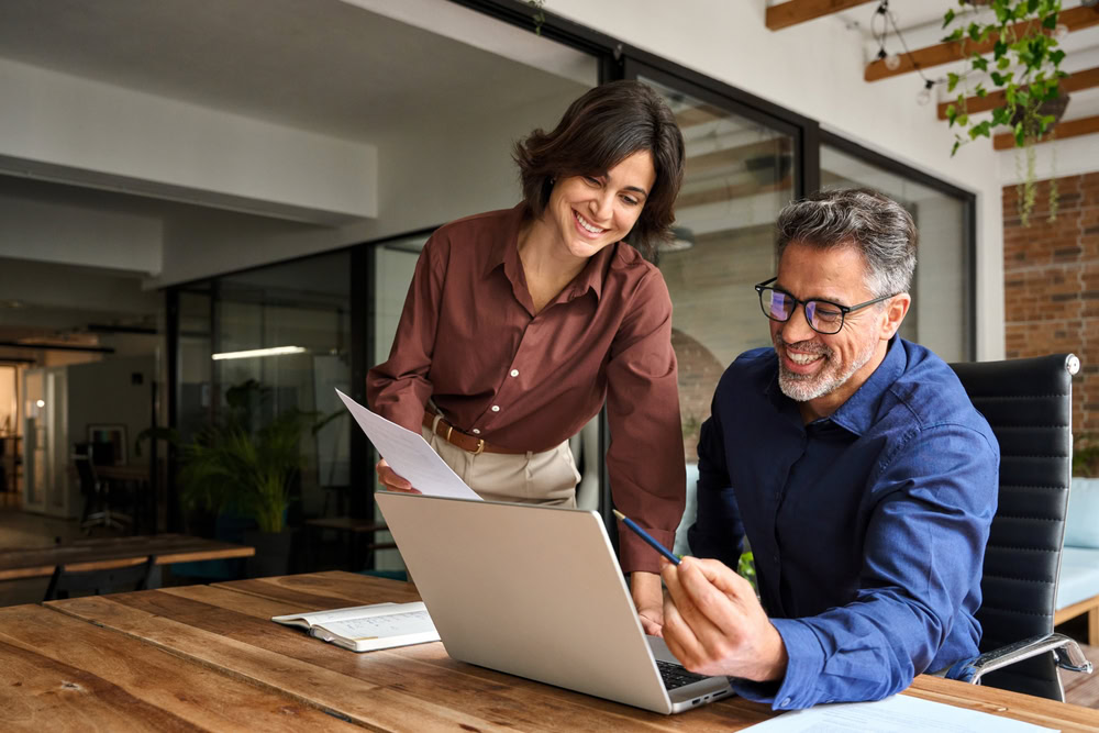 shutterstock_2510293371 (1) A woman and a man discussing visa investment options