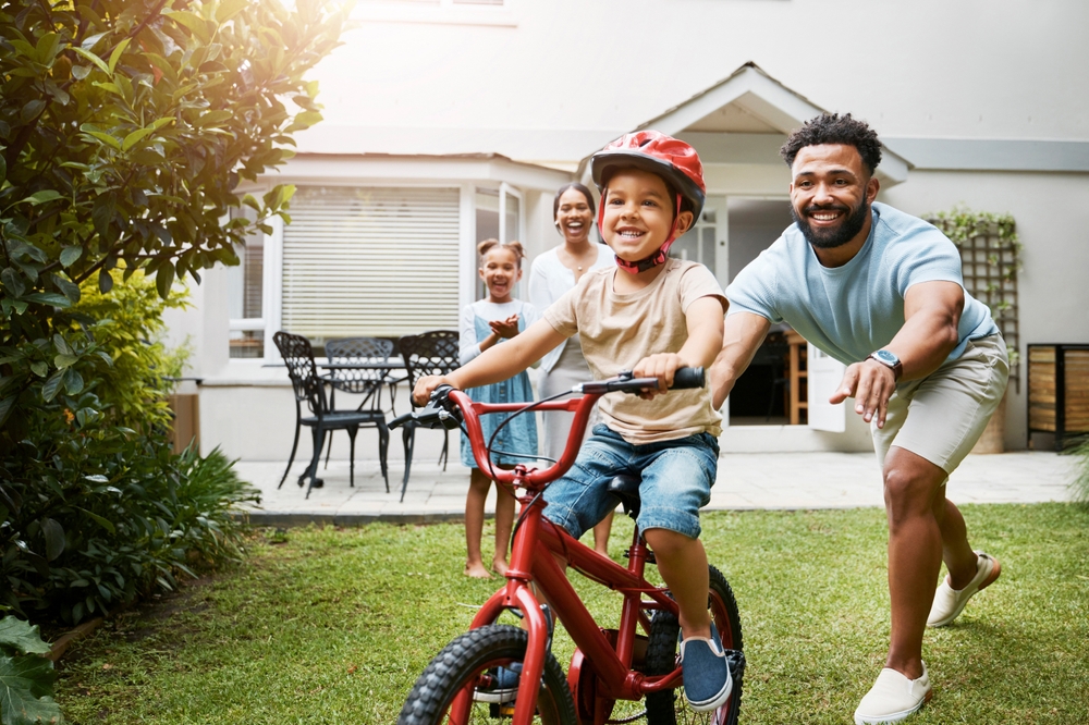 Learning,,Bicycle,And,Proud,Dad,Teaching,His,Young,Son,To Your family deserves to live in a safe part of the world