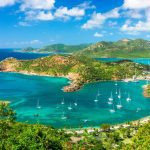 An aerial view of a beach, representing Antigua and Barbuda’s safety and tranquility.