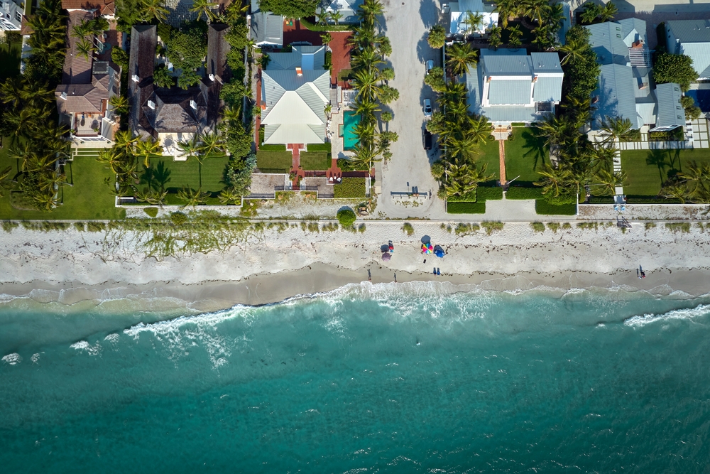 Wealthy,Waterfront,Residential,Area.,Rich,Neighborhood,With,Expensive,Vacation,Homes An aerial view of beachside mansions in one of the cities with the most millionaires worldwide.